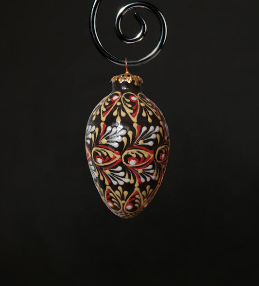 Small ceramic ornament in red, yellow, white