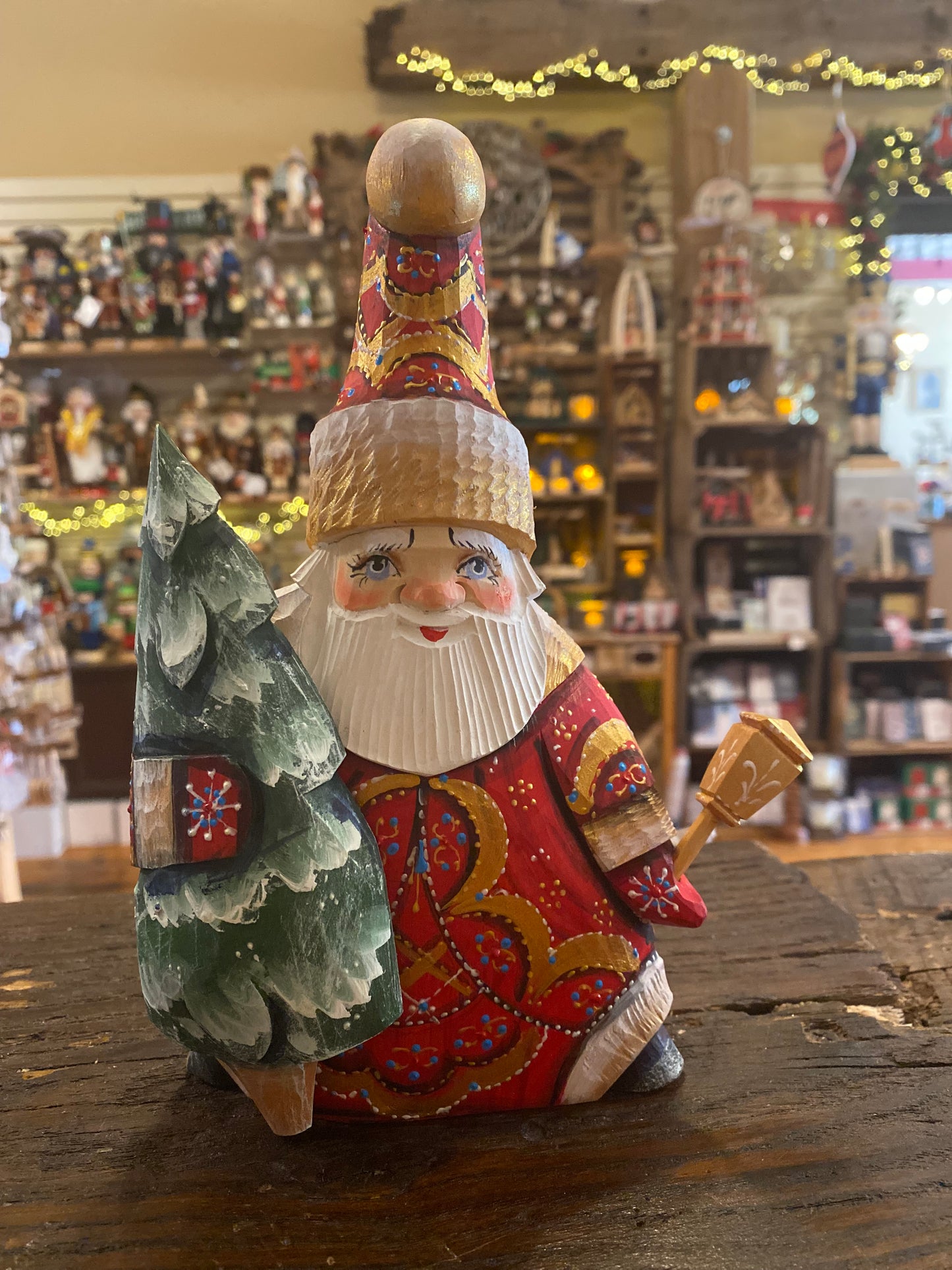 Wood-carved santa with tree - large