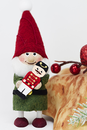 Santa Gnome in Green Holding Nutcracker